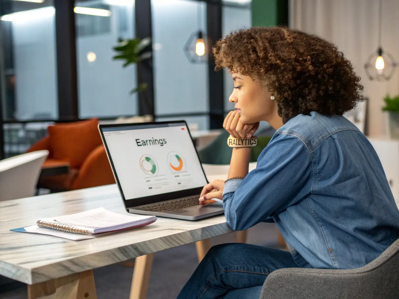 An image of a person working on a laptop, showcasing a dashboard with passive income metrics and growth charts.